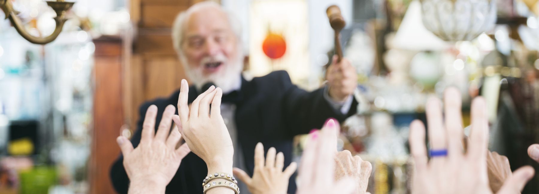 Auctioneer with Large Crowd of Buyers